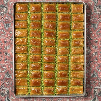 Baklava on a metal tray with a patterned background